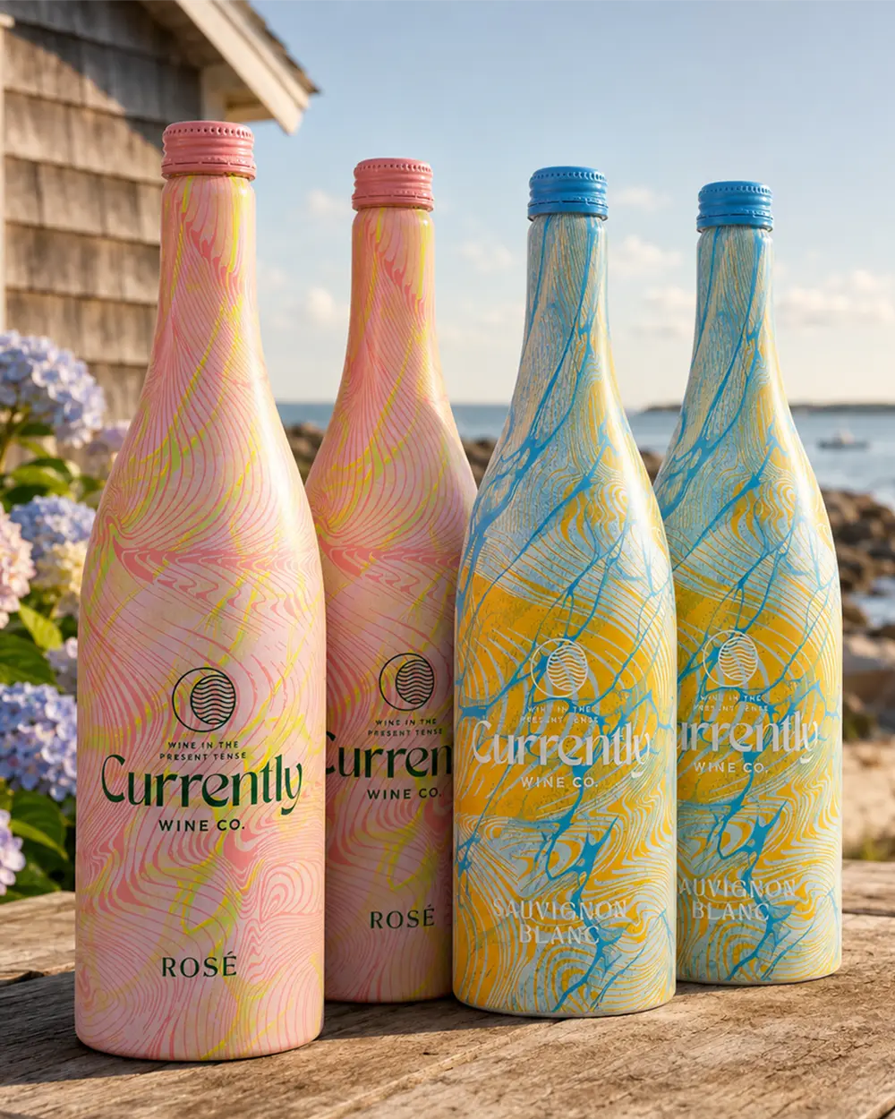 Currently Wine Co. 4-pack: two Rosé and two Sauvignon Blanc aluminum bottles on a deck by the water